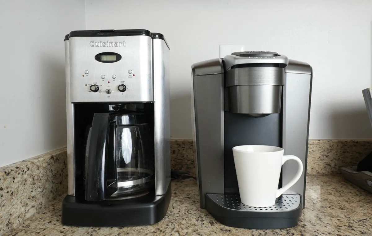A close-up of the coffee-making station showcasing both a drip and single-cup coffee maker, a white coffee mug, and a clean, inviting countertop. The setup is perfect for morning routines or casual conversations.